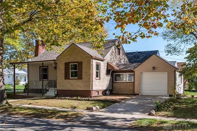 view of front of property with driveway, stone siding, a chimney, roof with shingles, and an attached garage