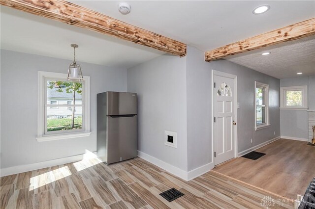 interior space with beam ceiling and hardwood / wood-style floors