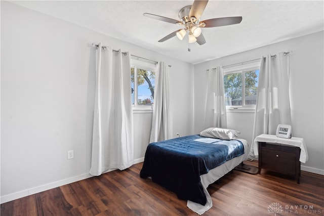 bedroom with ceiling fan and dark wood-type flooring