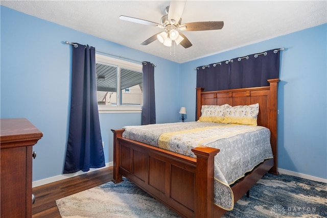 bedroom with ceiling fan and dark wood-type flooring