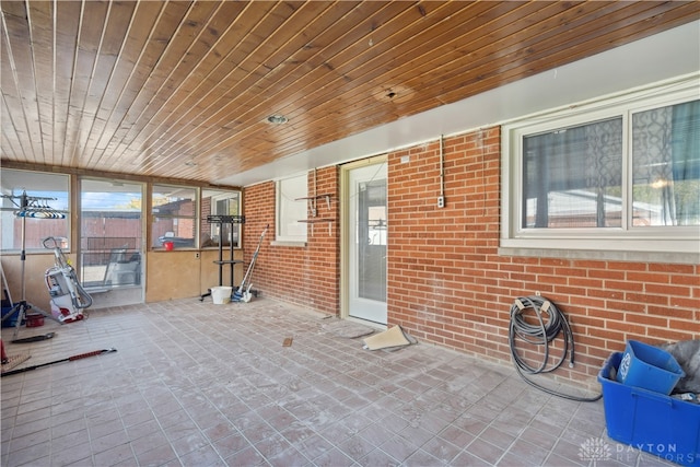 unfurnished sunroom featuring wooden ceiling