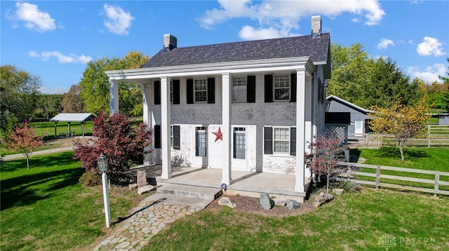 back of property with a patio and a yard