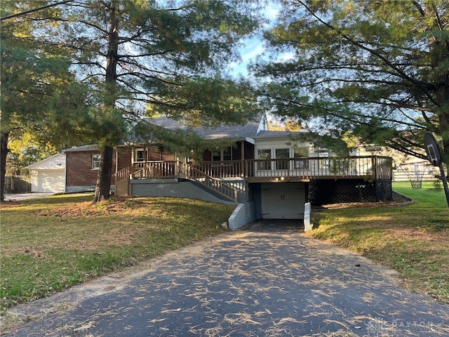 view of front facade with a deck and a front lawn