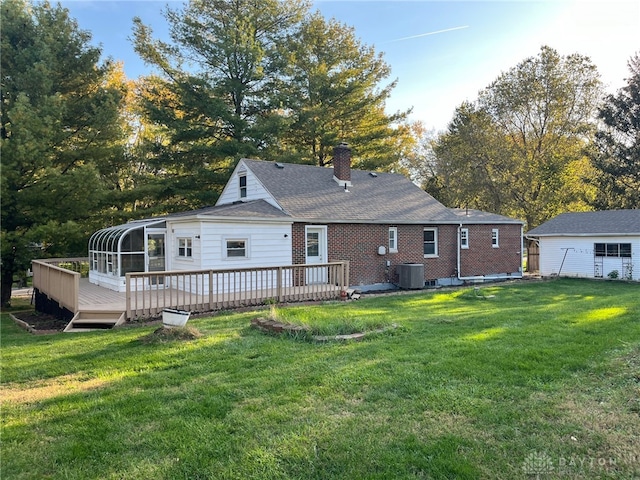 back of property with central AC unit, a sunroom, a yard, and a wooden deck