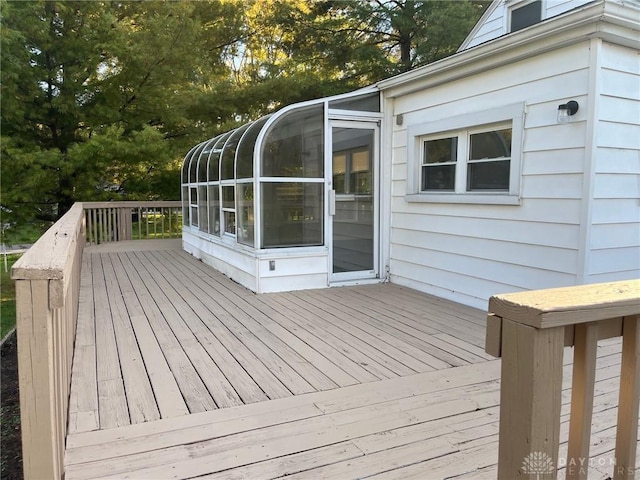 wooden deck featuring a sunroom