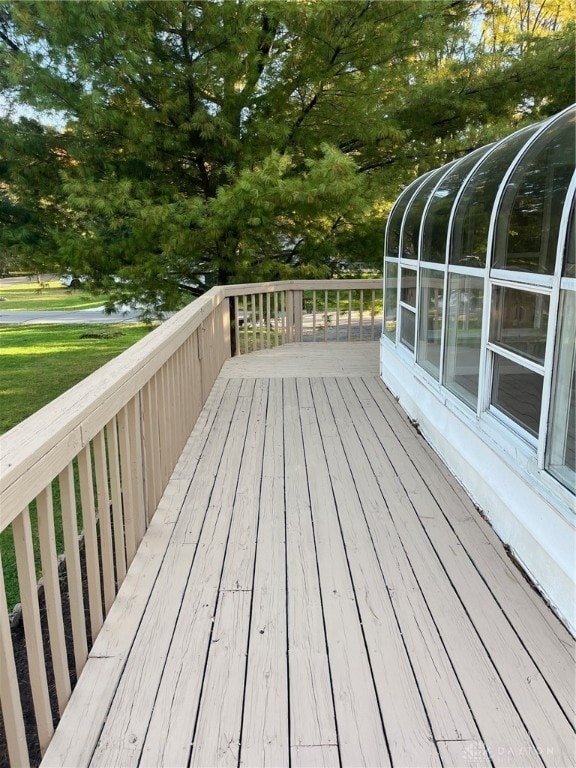 wooden deck featuring a sunroom