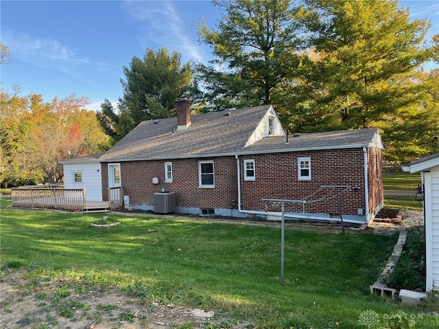 back of property featuring a yard, cooling unit, and a deck