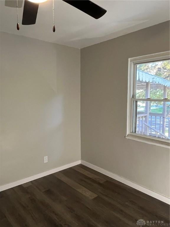 empty room with dark wood-type flooring and ceiling fan