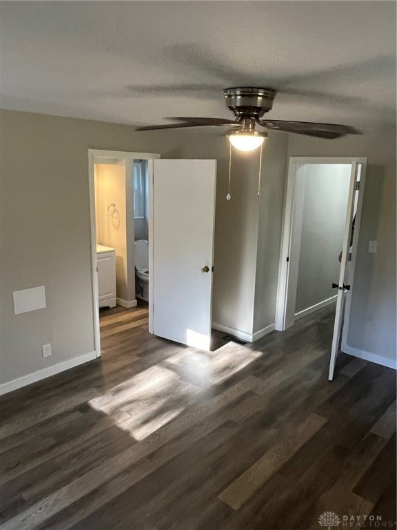 spare room with ceiling fan and dark wood-type flooring