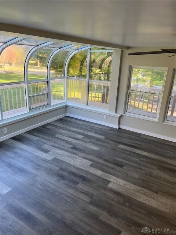 unfurnished sunroom featuring ceiling fan