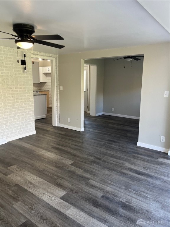 unfurnished living room with ceiling fan and dark hardwood / wood-style flooring