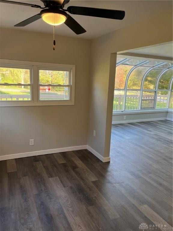 unfurnished room with dark wood-type flooring and ceiling fan