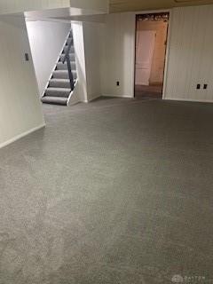 interior space featuring carpet floors and wood walls