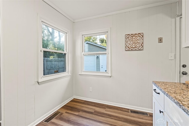 interior space featuring ornamental molding and dark wood-type flooring