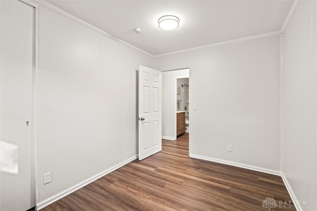 unfurnished bedroom featuring crown molding and dark hardwood / wood-style floors