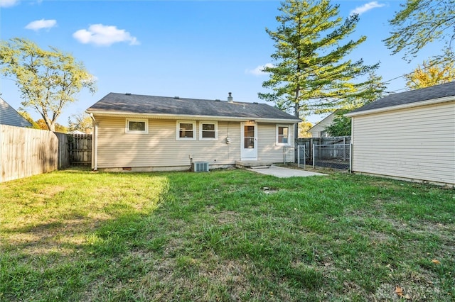 back of house featuring a patio area, a lawn, and central AC unit