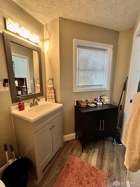 bathroom with vanity, hardwood / wood-style floors, and a textured ceiling