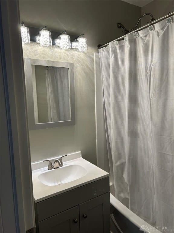 bathroom with vanity and shower / bath combination with curtain