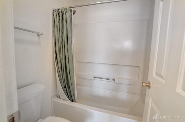 bathroom with shower / bath combo and toilet