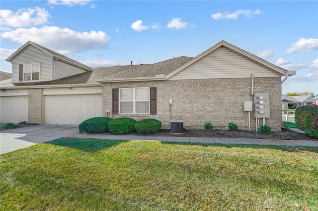 view of front of home with a front yard and central AC unit