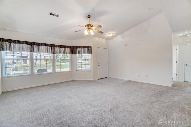 carpeted empty room featuring lofted ceiling and ceiling fan