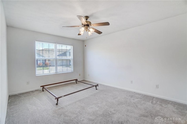 spare room with light colored carpet and ceiling fan