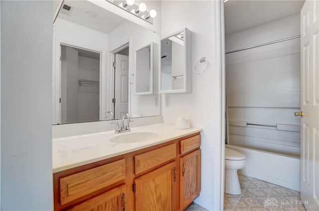 full bathroom featuring toilet, vanity, and shower / bathtub combination