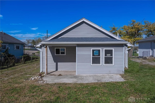 rear view of property with a lawn