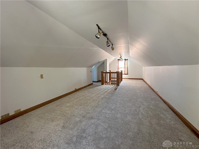 bonus room with carpet and vaulted ceiling