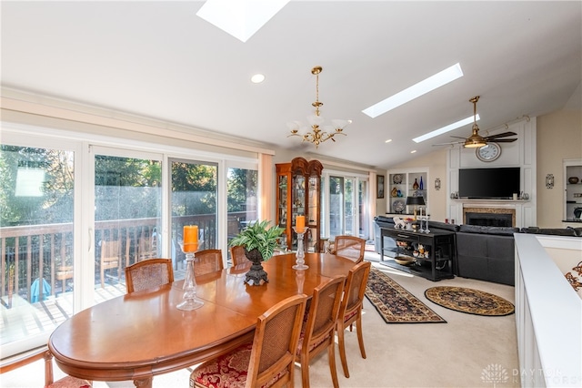 dining space featuring lofted ceiling and ceiling fan with notable chandelier