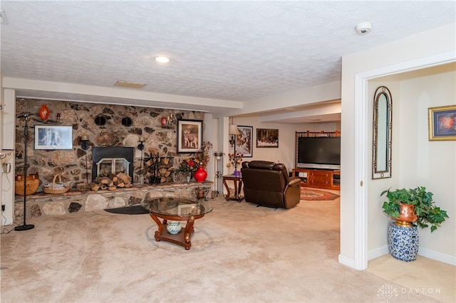 carpeted living room with a textured ceiling and a fireplace