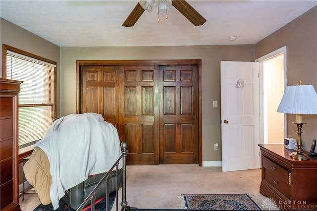 carpeted bedroom with a closet and ceiling fan