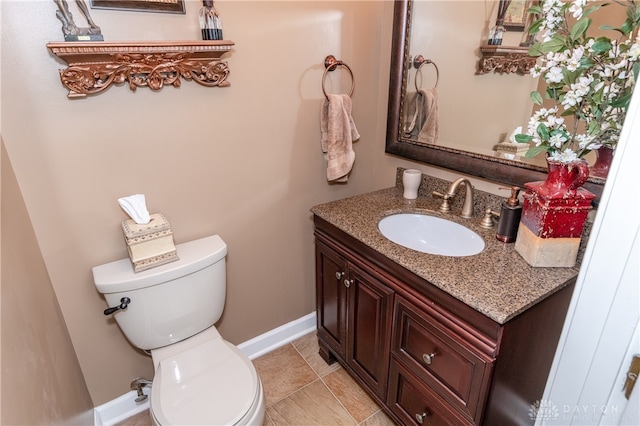 bathroom featuring vanity, toilet, and tile patterned flooring