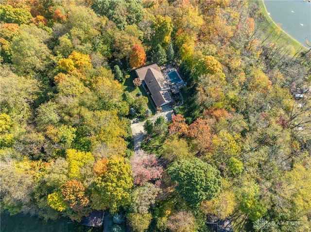 birds eye view of property with a water view and a wooded view