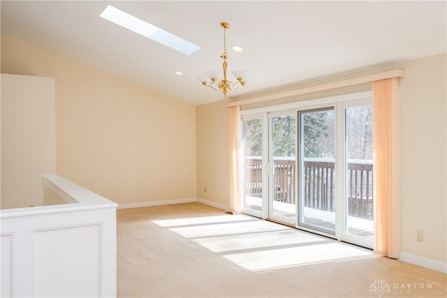 unfurnished room featuring lofted ceiling with skylight, light carpet, baseboards, and an inviting chandelier