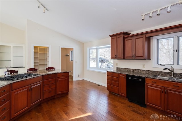 kitchen with a sink, dark stone countertops, and dishwasher