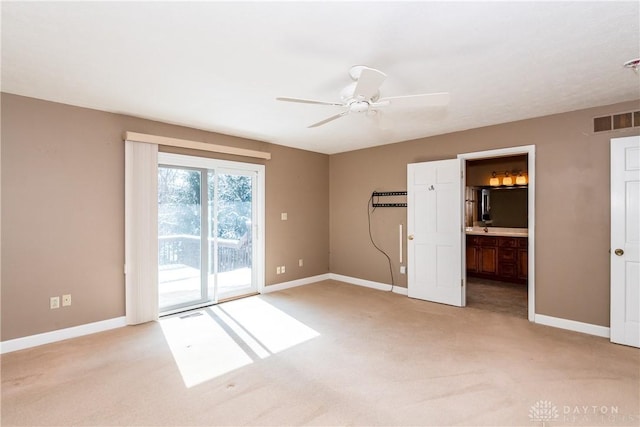 spare room featuring visible vents, light carpet, and baseboards