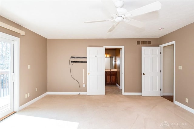 unfurnished bedroom with light colored carpet, access to outside, visible vents, and baseboards