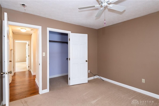 unfurnished bedroom with a closet, carpet flooring, and baseboards