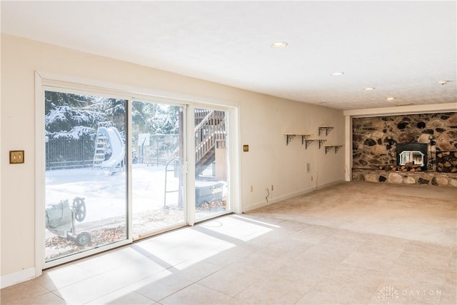 unfurnished living room with light carpet, baseboards, and recessed lighting