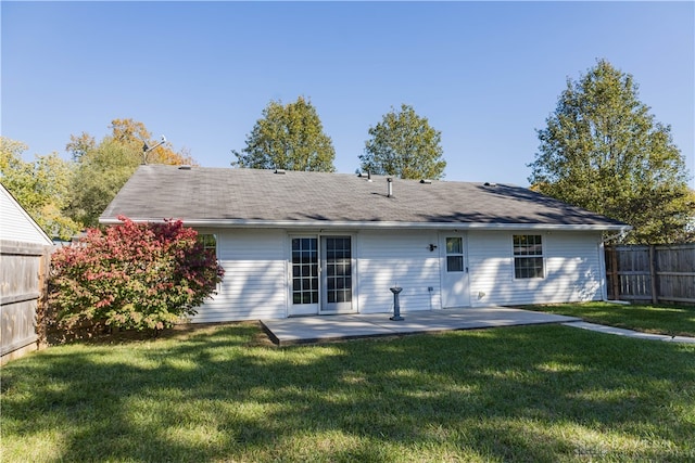 rear view of property featuring a yard and a patio