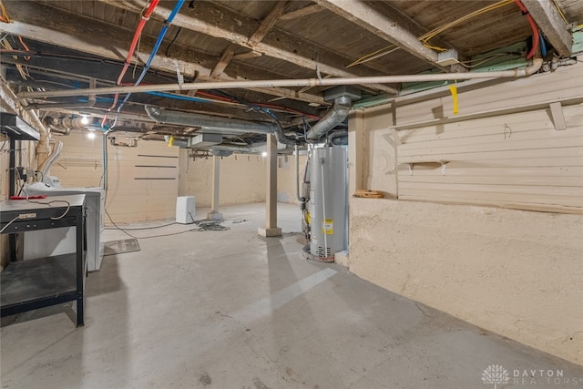 basement featuring water heater and washing machine and dryer