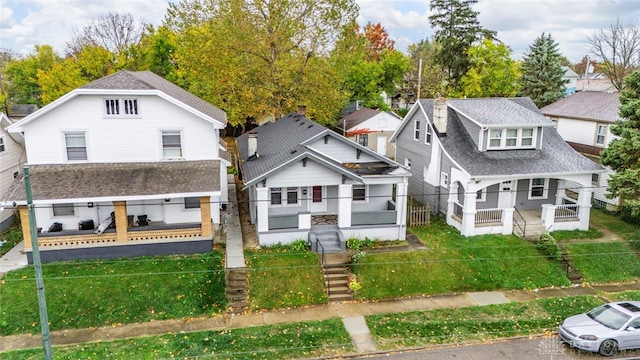 view of front of property featuring covered porch and a front lawn