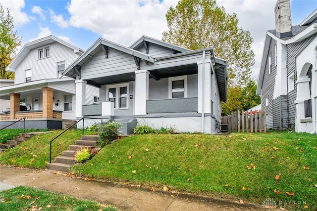 view of front of home featuring covered porch and a front yard