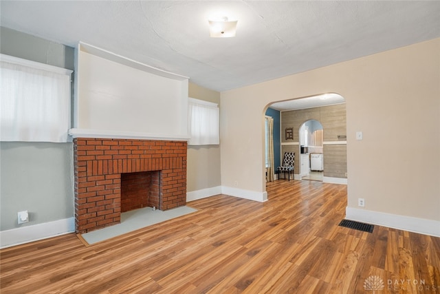 unfurnished living room with hardwood / wood-style flooring and a fireplace