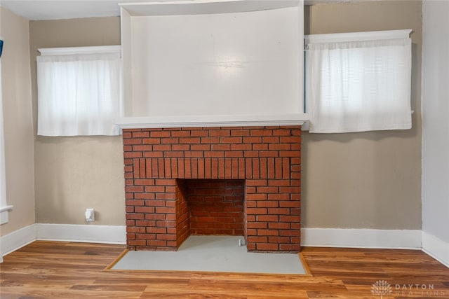 room details featuring a brick fireplace and hardwood / wood-style floors