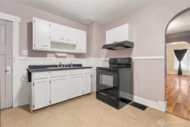 kitchen featuring white cabinetry, light hardwood / wood-style flooring, electric range, and sink