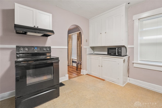 kitchen with white cabinetry, black appliances, and a textured ceiling