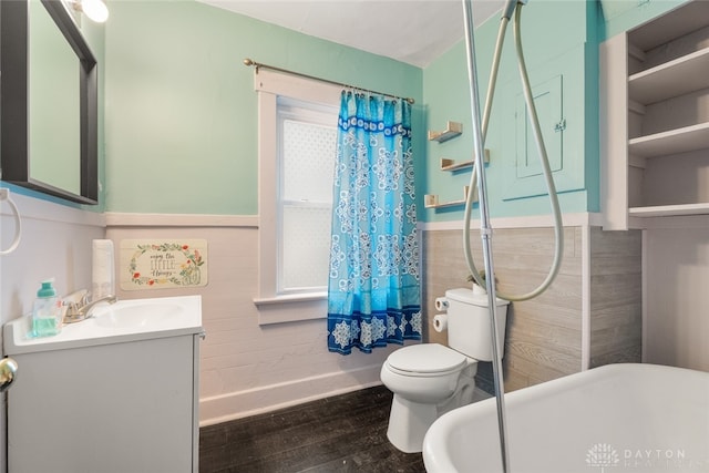 bathroom with vanity, toilet, tile walls, and hardwood / wood-style floors