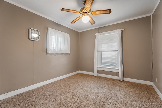 unfurnished room with ornamental molding, carpet flooring, and plenty of natural light